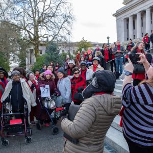 Advocates in their red scarves gather on the Capitol steps in Olympia during HHAD in 2020.