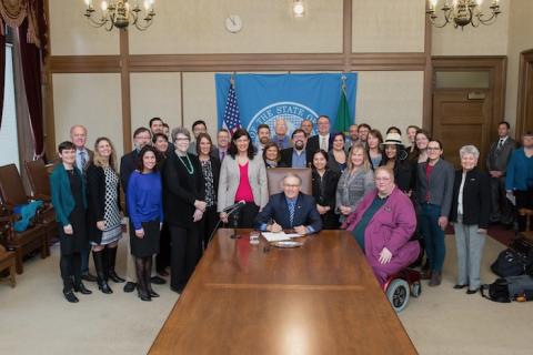Advocates and lawmakers gathered for a bill signing in Olympia.
